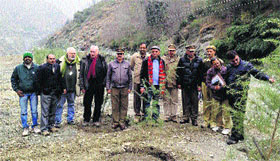 A German team takes stock of a plantation drive on the left bank of the Ravi near Dharwala in Chamba district.