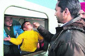 In safe hands: A child being administered polio drops at the city railway station by the Health Department staff in Jalandhar on Sunday