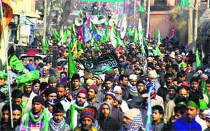 Devotees take part in the Milad procession at Shalimar on the outskirts of Srinagar on Sunday. 