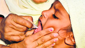 A child is administered polio drops at the Ludhiana railway station on Sunday.