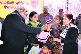 Health Minister Surjit Kumar Jyani administer a polio vaccine to a child in Fazilka on Sunday