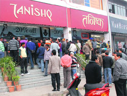 Residents gather outside the Tanishq showroom after the heist at Mani Majra on January 12, 2011. A file photo