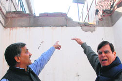 Shopkeepers show the wall broken by thieves on the rear side of a showroom at Sector 20 in Panchkula on Monday. Tribune Photo: Nitin Mittal