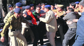 Policemen arrest the BPEd and MPEd unemployed youth, who were protesting in front of the MLA hostel in Dehradun on Monday.
