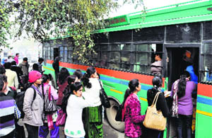 People board private buses during the roadways strike in Karnal on Monday. 
