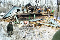Security forces personnel try to recover the body of a militant from the rubble of a house at the Shempora area of Anantnag district on Monday. Tribune Photo: Amin War