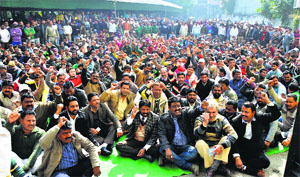 Members of the Municipal Karamchari Dal (Punjab) shout slogans outside the MC office in Ludhiana on Monday. 