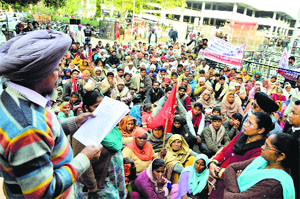 CITU leader Tarsem Jodhan addresses workers during a dharna at the Mini-Secretariat on Monday.