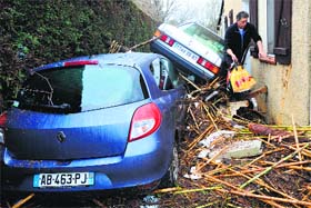 A man makes his way through a flood-ravaged street at La Londe-les-Maures in southeastern France on Monday
