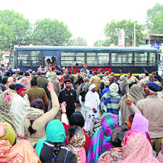 Haryana Roadways employees owing allegiance to the Sarv Karamchari Sangh raise slogans as the police detain their leaders at Bhiwani on Tuesday