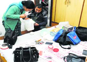 Fingerprint experts conduct investigations at the deceased woman's house in the Green Park locality on Tuesday