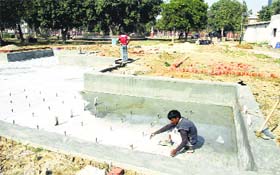 A worker cleans the fountains at Nehru Garden in Jalandhar
