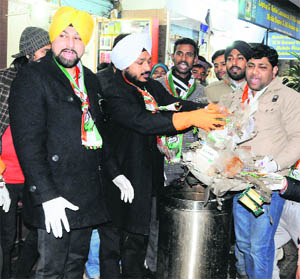 Congress councillor Gurinder Rishi (centre) and his supporters lift garbage at Hall Bazar in Amritsar on Wednesday.