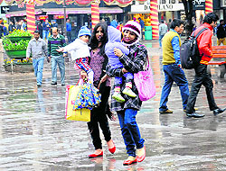 Rain no dampener: Visitors and shoppers enjoy a walk in showers at Sector 17, Chandigarh, on Wednesday