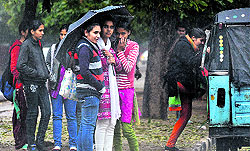 Girls brave the winter rain outside the GCG-11 in Chandigarh on Wednesday