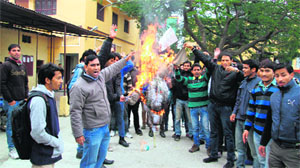 Members of Students Federation of India (SFI) burn an effigy of West Bengal Chief Minister Mamta Banerjee in Dehradun on Wednesday. 