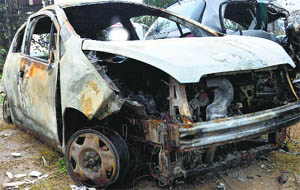 The damaged car that caught fire near Manawala on the Amritsar-Jalandhar highway on Wednesday.