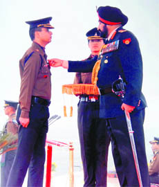 Major Abhishek Kukreti gets the Sena Medal from the Chief of Army Staff Bikram Singh during the Army Day function in New Delhi recently.