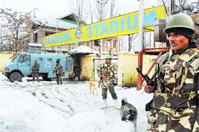Paramilitary soldiers stand guard outside Bakshi Stadium, the venue for the Republic Day parade in Srinagar, on Thursday