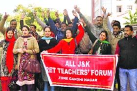 Members of the Jammu and Kashmir Rehbar-e-Taleem Teachers Forum protest outside the Divisional Commissioners office in Jammu on Thursday