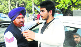 A youth argues with a policeman