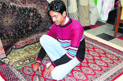 An artisan works on a carpet in Amritsar. Tribune photo: Vishal Kumar