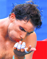 Rafael Nadal has been forced to play the Australian Open with strapping across his left hand due to a blister.