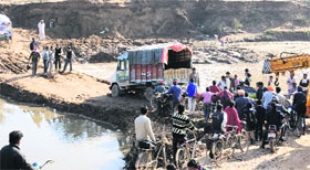 A truck stuck on the makeshift bridge at Jagatpura village on Friday.