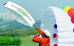 A man flies a kite at the Third International Kite Festival-2014 near Old Yamuna Iron Bridge in New Delhi on Friday