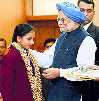 Prime Minister Manmohan Singh presents the Bapu Gaidhani Award to Shilpa Sharma of Bilaspur at the National Bravery Awards function in New Delhi on Friday. Shilpa displayed courage and saved her brother from a leopard
