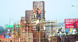 Labourers fix iron bars on one of the pillars being constructed for the 1.5-km Bikram Chowk-Gandhi Nagar flyover in Jammu.