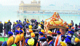 Devotees participate in a procession held on the eve of Shaheed Baba Deep Singhs birth anniversary at the Golden Temple in Amritsar on Saturday.