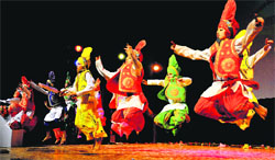 Students perform bhangra at a function on the Republic Day eve at Tagore theatre in Chandigarh