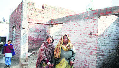 Families living under roofless houses at the Kot Ram Das colony in Jalandhar.