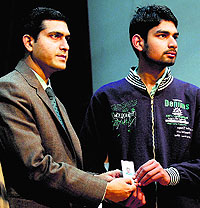 Ludhiana Deputy Commissioner Rajat Aggarwal hands over a voter ID card to a student at the Government College for Women on Saturday