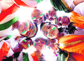Students paint the Tricolour on their faces on the eve of Republic Day in Jalandhar on Saturday.