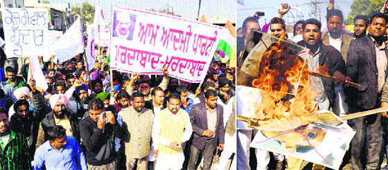Members of Bhagwan Valmiki Kranti Sena hold a protest; and (right) activists burn a poster of Delhi Chief Minister Arvind Kejriwal in Amritsar on Sunday.