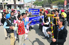 Members of the Unaided Staff Front, Punjab, use folk musical instruments while protesting against the state government in Bathinda on Monday