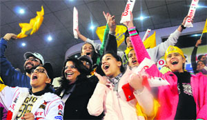 Fans cheer their favourite teams during a match of the ongoing Hockey Indian League at the Phase IX stadium in Mohali on Sunday