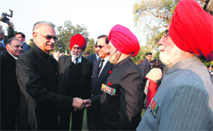 Punjab Governor and UT Administrator Shivraj V Patil interacts with a former Armyman during the At Home at the Punjab Raj Bhawan in Chandigarh on Sunday.