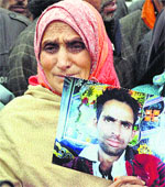 The mother of a truck driver arrested in Pakistan presses for his release in Baramulla on Monday. Twentyseven Indian truck drivers are under detention in Pakistan.