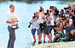 Stanislas Wawrinka laughs as he poses on the banks of the Yarra river with the Norman Brookes Challenge Cup on Monday. Reuters