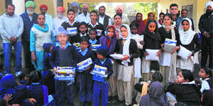 Students with school uniform and other items donated by Guru Gobind Singh Refinery at Phullokhari village (Bathinda) on Tuesday.