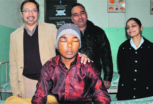 Dr JS Sra (left) with the 12-year-old boy whose vision in the right eye has been partially restored.