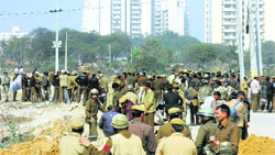 Heavy police force was deployed after villagers attacked HUDA officials in Gurgaon on Tuesday. Tribune photo
