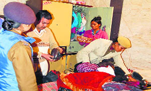 Police officials conduct a search operation at a house in the Pucca Bagh locality on Tuesday. 