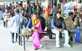 Passengers stranded at the general bus stand in Jammu on Tuesday as transporters went on a strike.