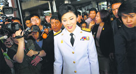 Thailand's Prime Minister Yingluck Shinawatra leaves the Army Club after meeting the Election Commission in Bangkok on Tuesday.