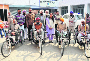ADC Sonali Giri with the handicapped persons who were given tricycles at the office of the Red Cross Society in Bathinda on Wednesday