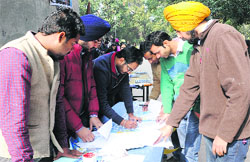 ABVP workers entertain visitors during a voter registration campaign at the Student Centre, Panjab University, in Chandigarh on Wednesday. Tribune Photo: S Chandan
